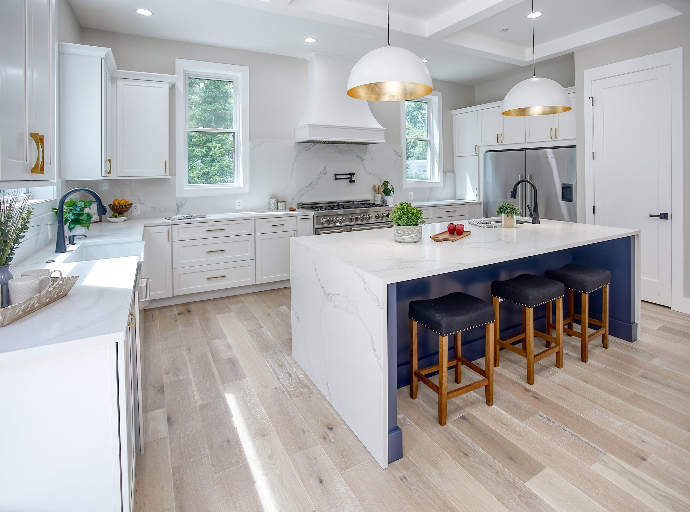 Kitchen with dark cabinetry and tall windows